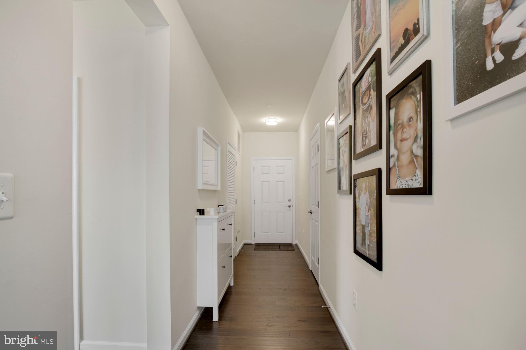 3825 Doc Berlin Drive, Unit 17 Silver Spring, MD 20906 - Photo 2 of 34 a view of a hallway with paintings on the wall