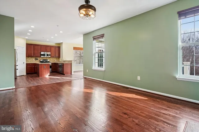 a view of a kitchen with a sink a refrigerator and a stove top oven