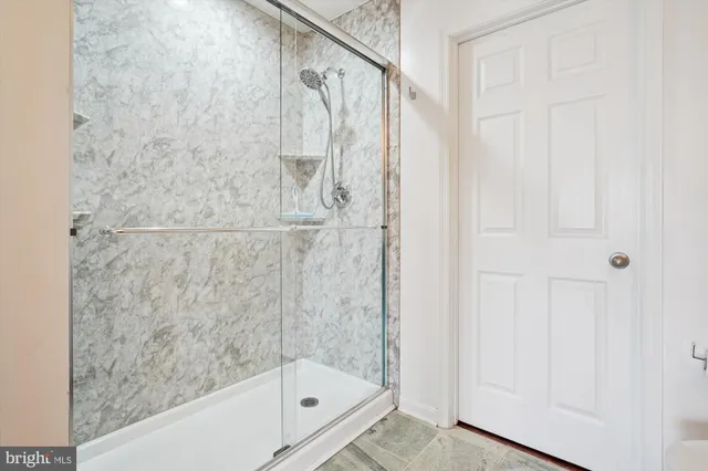 a view of a big room with wooden floor and windows