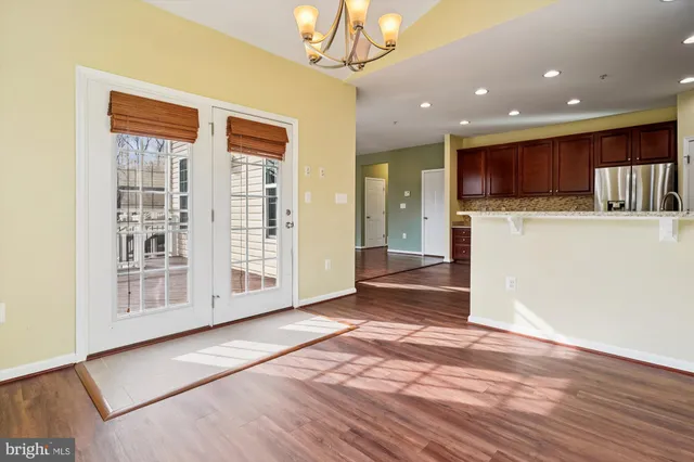 a view of kitchen with stainless steel appliances granite countertop cabinets and wooden floor