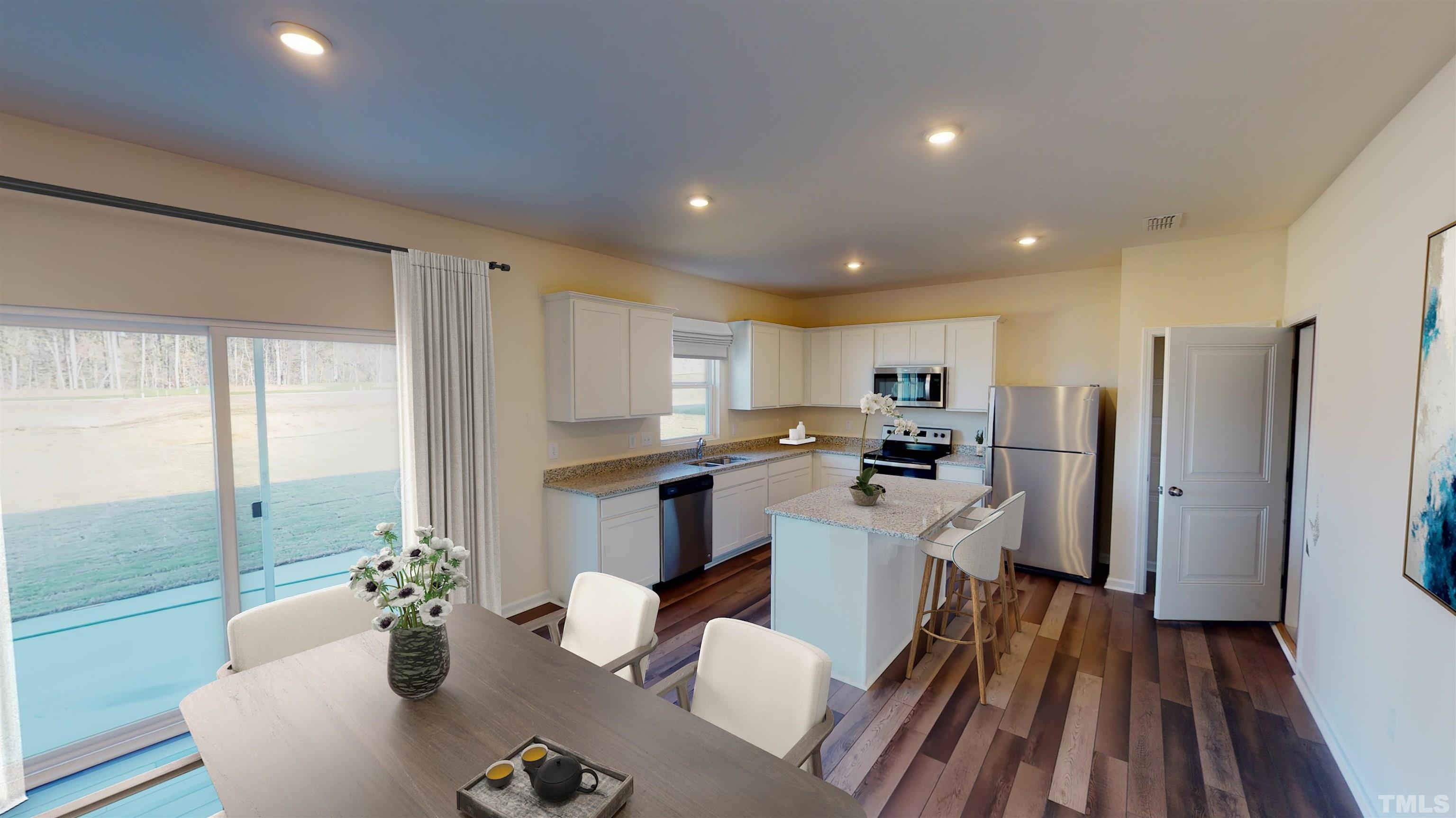 1528 Crested Iris Street Raleigh, NC 27604 - Photo 17 of 24 a kitchen with sink refrigerator and microwave