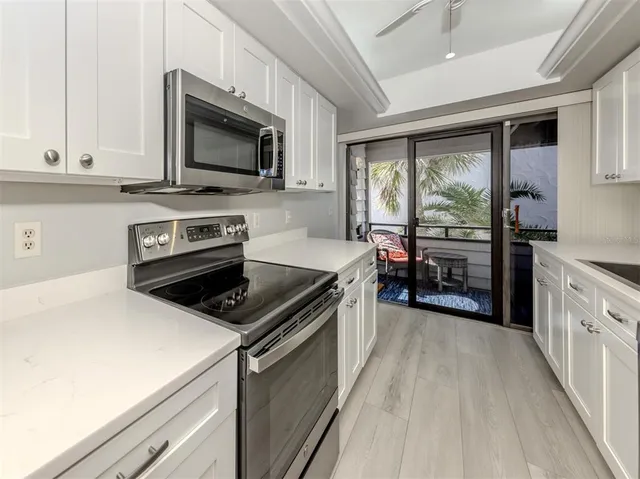 a kitchen with a stove a sink and a microwave