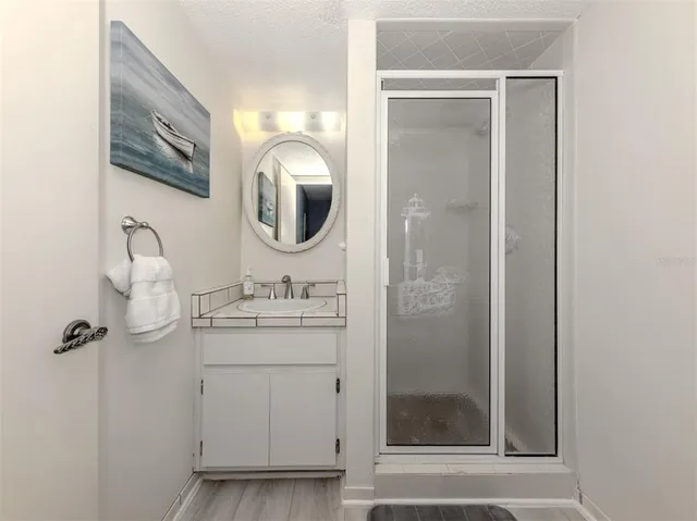 a bathroom with a granite countertop sink mirror and vanity