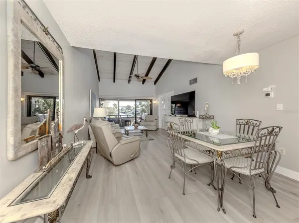 a view of a dining room with furniture wooden floor and chandelier
