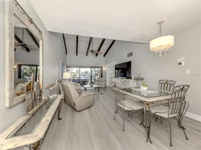 a view of a dining room with furniture wooden floor and chandelier