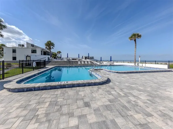 a swimming pool with outdoor seating