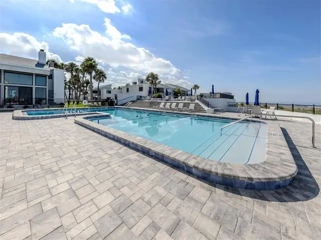 a view of a swimming pool and lounge chair
