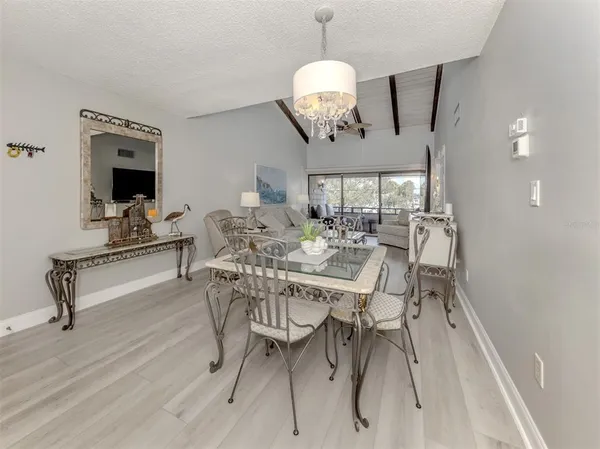 a view of a dining room with furniture wooden floor and chandelier