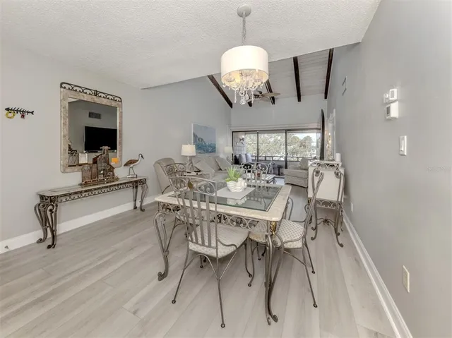 a view of a dining room with furniture wooden floor and chandelier