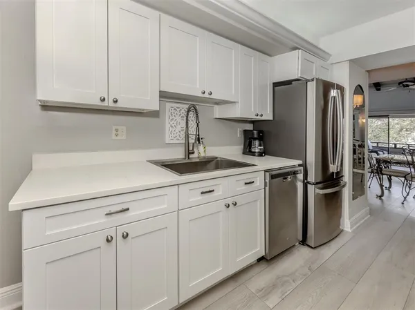 a kitchen with cabinets and stainless steel appliances