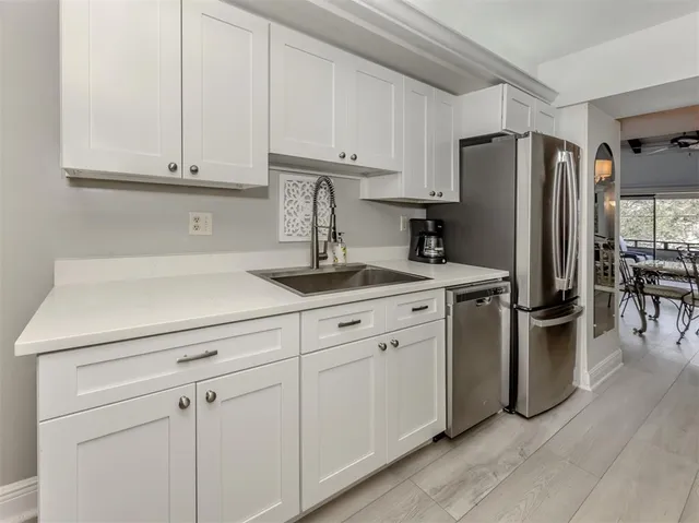 a kitchen with cabinets and stainless steel appliances