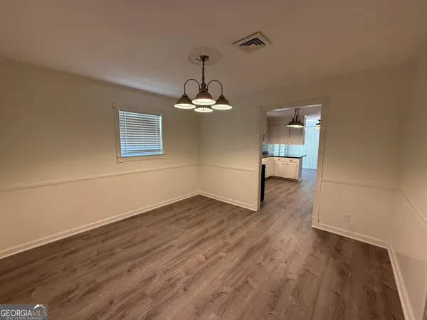 a view of a room with wooden floor and a window