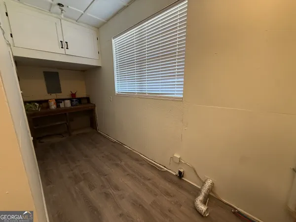 a room with a wooden cabinet and a window