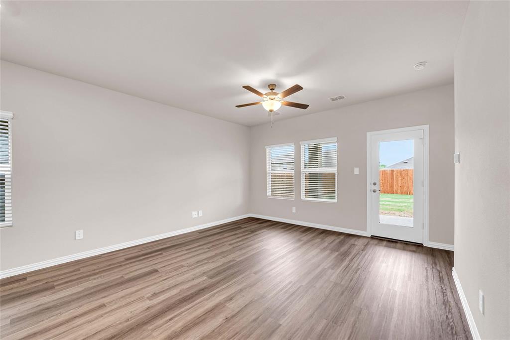 504 Weller Road Lowry Crossing, TX 75069 - Photo 14 of 32 a view of an empty room with a window and wooden floor