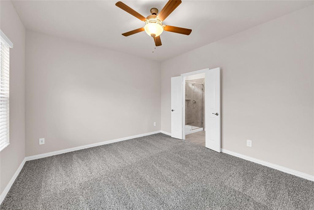 504 Weller Road Lowry Crossing, TX 75069 - Photo 17 of 32 an empty room with closet and a ceiling fan
