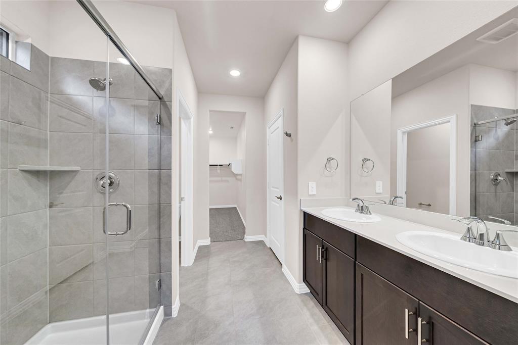 504 Weller Road Lowry Crossing, TX 75069 - Photo 20 of 32 a bathroom with a double vanity sink mirror double shower and a glass door