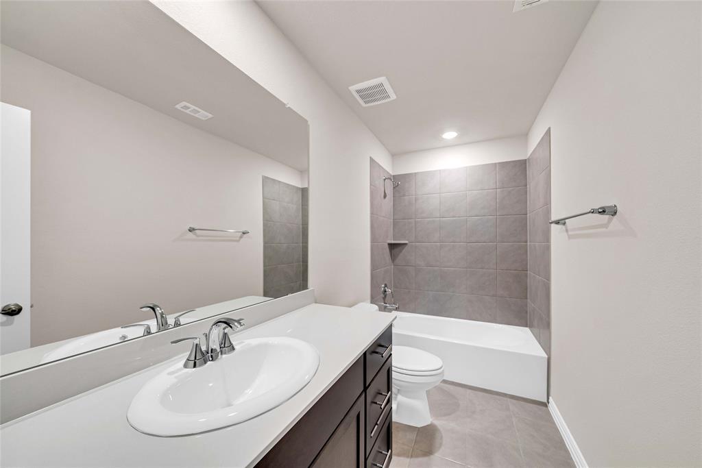 504 Weller Road Lowry Crossing, TX 75069 - Photo 26 of 32 a bathroom with a sink a toilet and shower