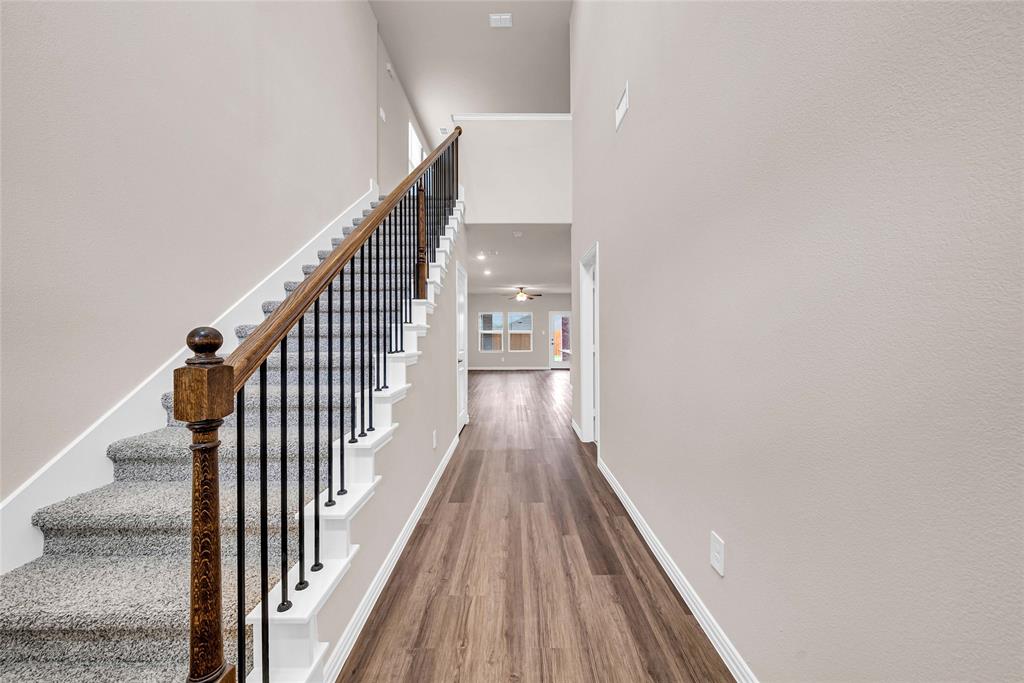 504 Weller Road Lowry Crossing, TX 75069 - Photo 5 of 32 a view of a hallway with wooden floor and staircase