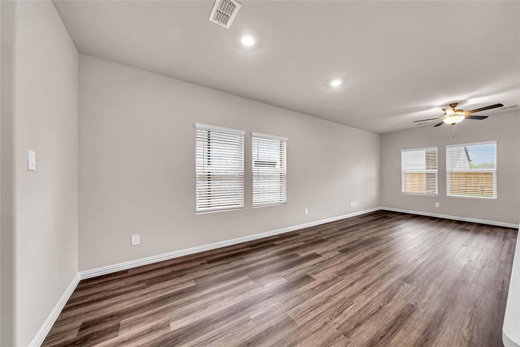 504 Weller Road Lowry Crossing, TX 75069 - Photo 9 of 32 wooden floor in an empty room with a window
