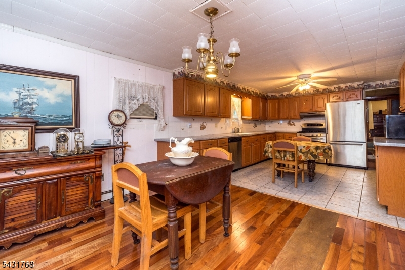 400 Mechlin Corner Road Pittstown, NJ 08867 - Photo 7 of 29 a view of a dining room with furniture and chandelier