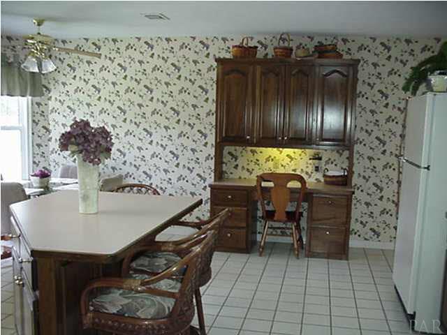 2442 Tate Road Cantonment, FL 32533 - Photo 6 of 15 Kitchen with island, built-in desk and breakfast nook.