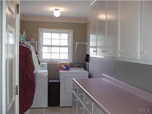 2442 Tate Road Cantonment, FL 32533 - Photo 8 of 15 Large laundry with cabinets, storage, built-in ironing board.
