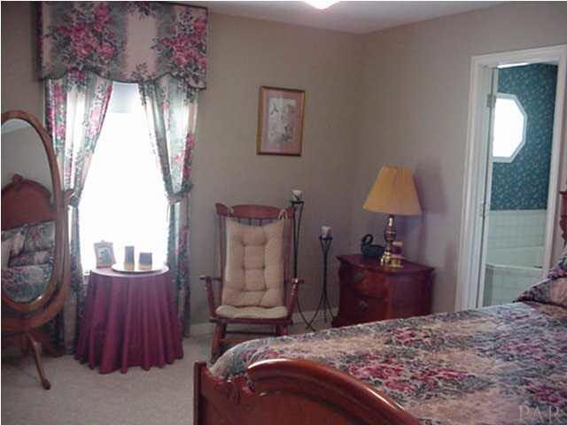 2442 Tate Road Cantonment, FL 32533 - Photo 9 of 15 Master bedroom with sitting area and view of pool.
