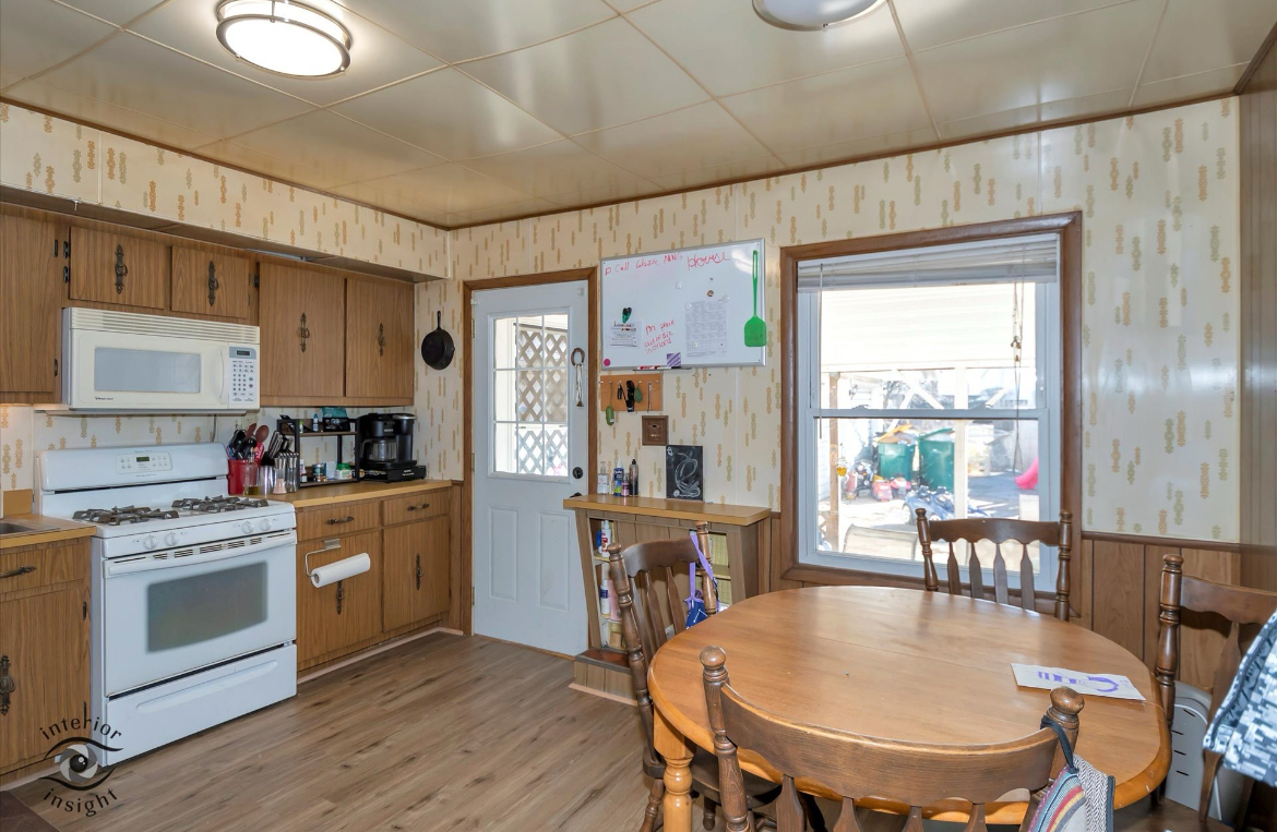 202 MacGregor Road Lockport, IL 60441 - Photo 7 of 26 a kitchen with stainless steel appliances granite countertop a stove a refrigerator a kitchen island a table and chairs with wooden floor