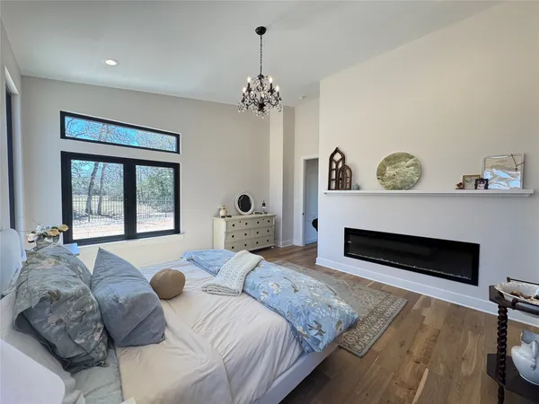 a living room with kitchen view and a fireplace