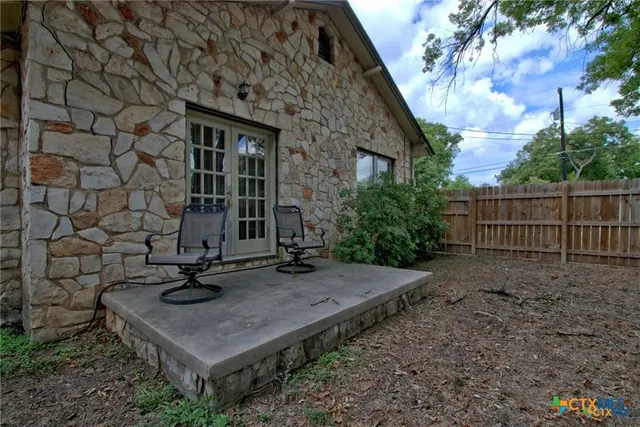 a view of a brick house with a sink and a yard