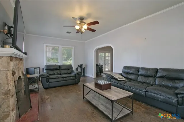a living room with furniture and a fireplace