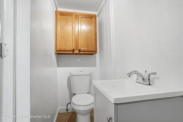 a bathroom with a sink a toilet and mirror