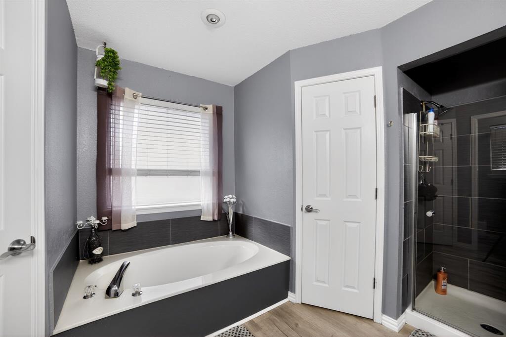 116 Curtis Lane Quinlan, TX 75474 - Photo 11 of 31 a bathroom with a bathtub and a shower