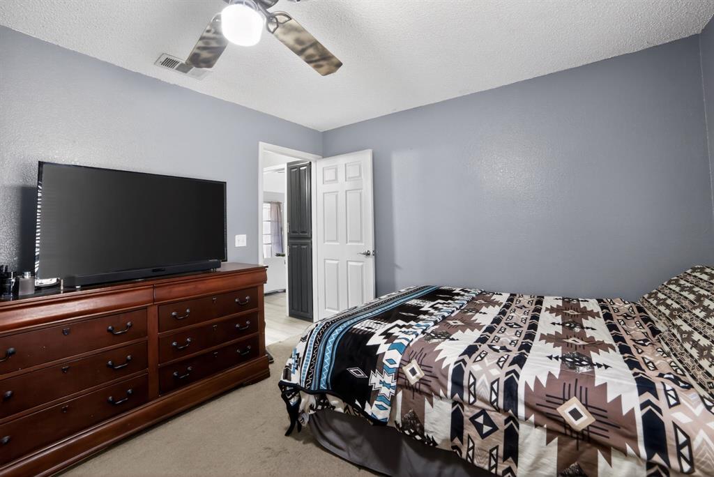 116 Curtis Lane Quinlan, TX 75474 - Photo 15 of 31 a bedroom with a bed and a flat screen tv