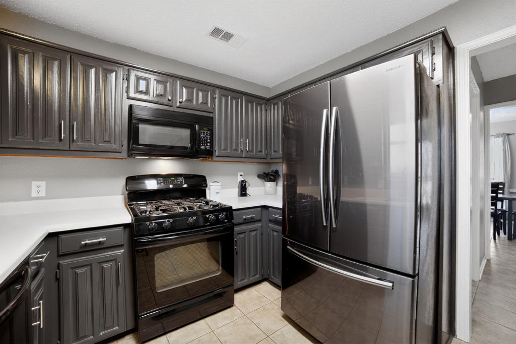 116 Curtis Lane Quinlan, TX 75474 - Photo 17 of 31 a kitchen with stainless steel appliances granite countertop a refrigerator stove and microwave