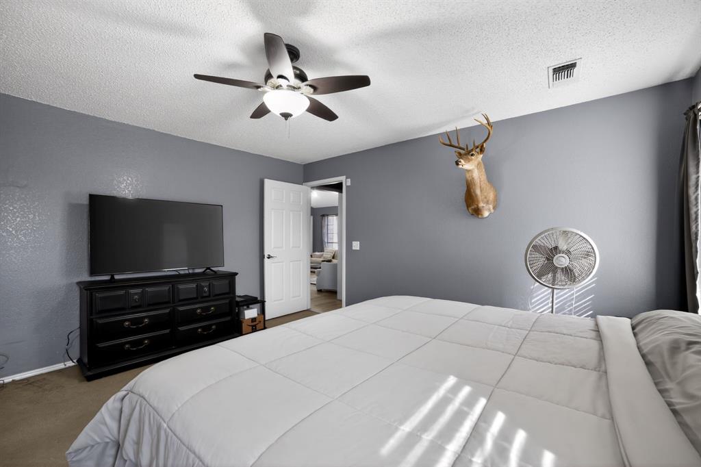 116 Curtis Lane Quinlan, TX 75474 - Photo 9 of 31 a bedroom with a bed and a flat screen tv