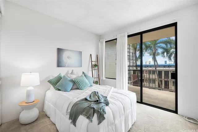 a bedroom with a bed and a large window