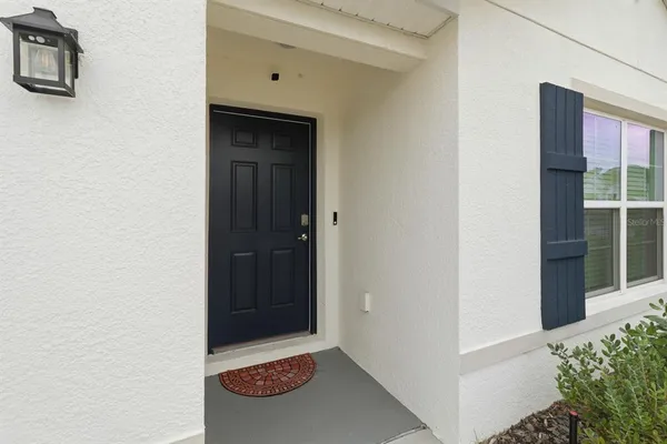 a view of a room with a mirror and fan
