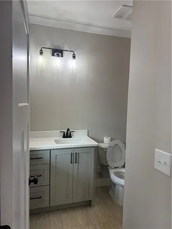 a bathroom with a granite countertop sink toilet and bathtub