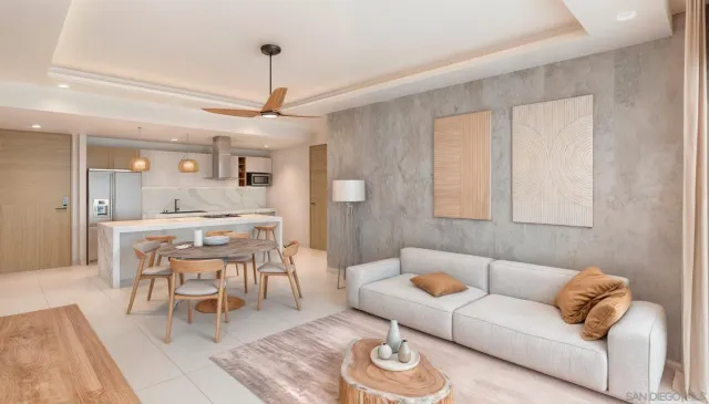 a open kitchen with a stove a refrigerator a sink a dining table and chairs with wooden floor