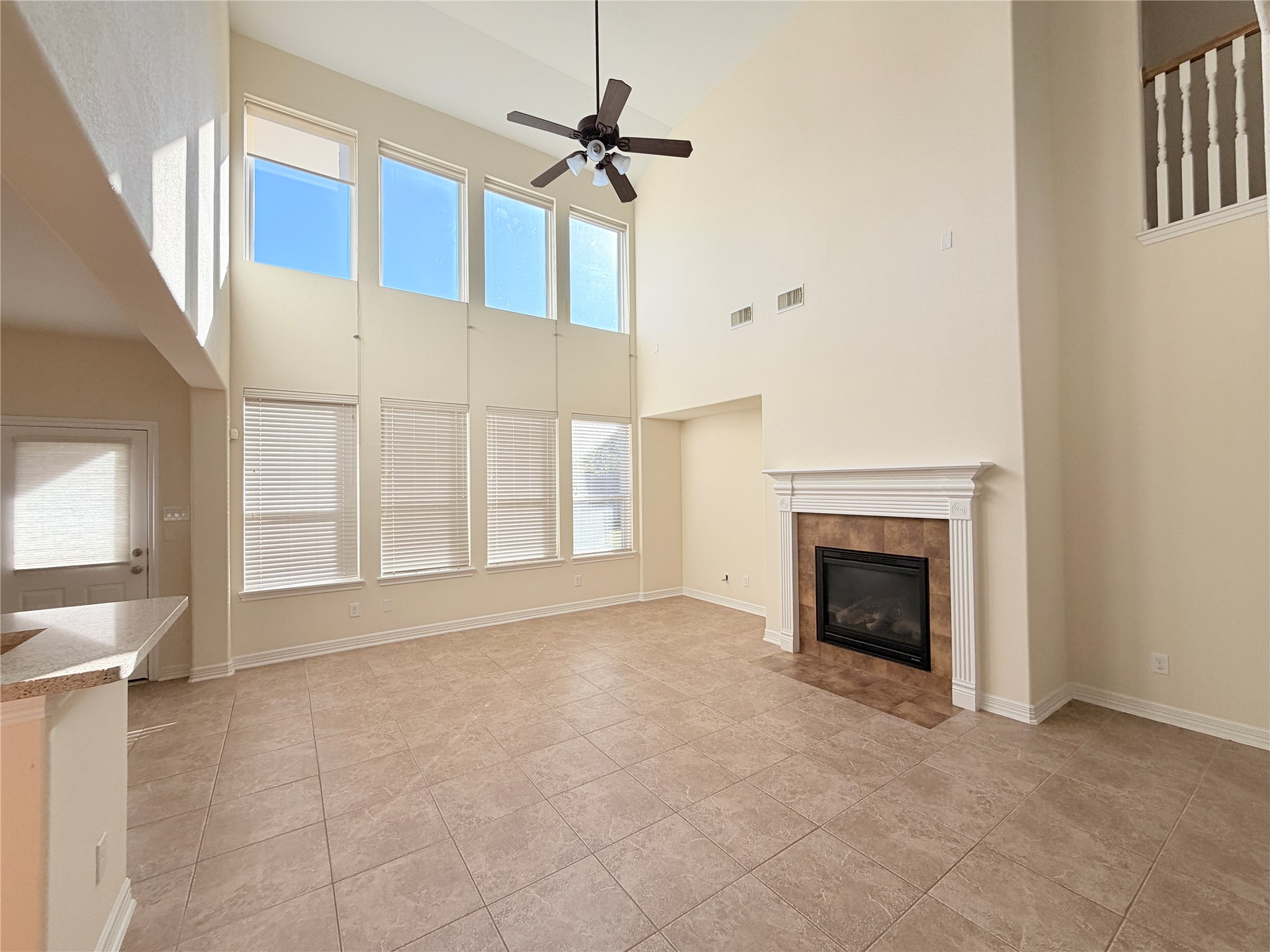 28015 Silverstream Court Fulshear, TX 77441 - Photo 12 of 33 a view of an empty room with a fireplace and a window