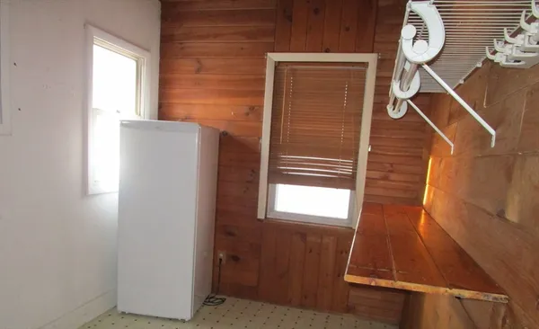 a view of a refrigerator in kitchen and entryway