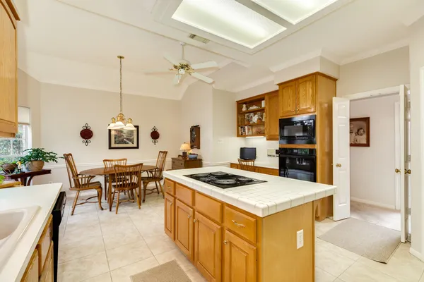 a kitchen that has a table and chairs in it