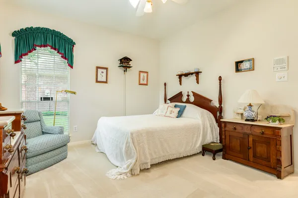 a bedroom with a bed and a couch