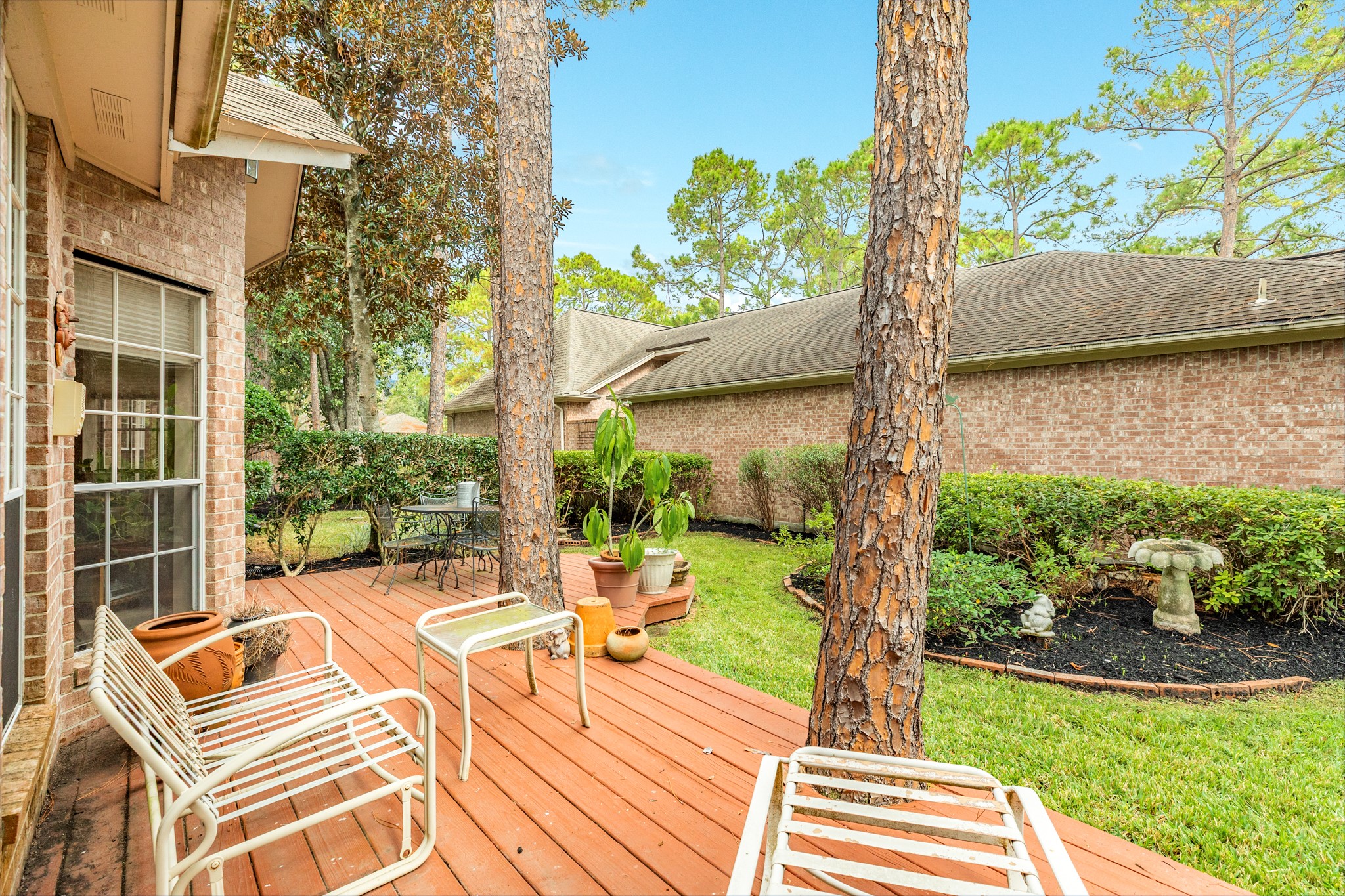 16522 Shadow Path Drive Pasadena, TX 77059 - Photo 32 of 33 a view of a patio with couches table and chairs and potted plants