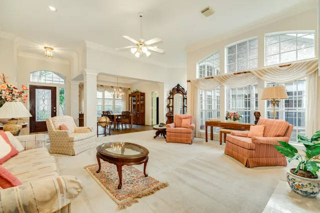 a living room with furniture a rug and a chandelier