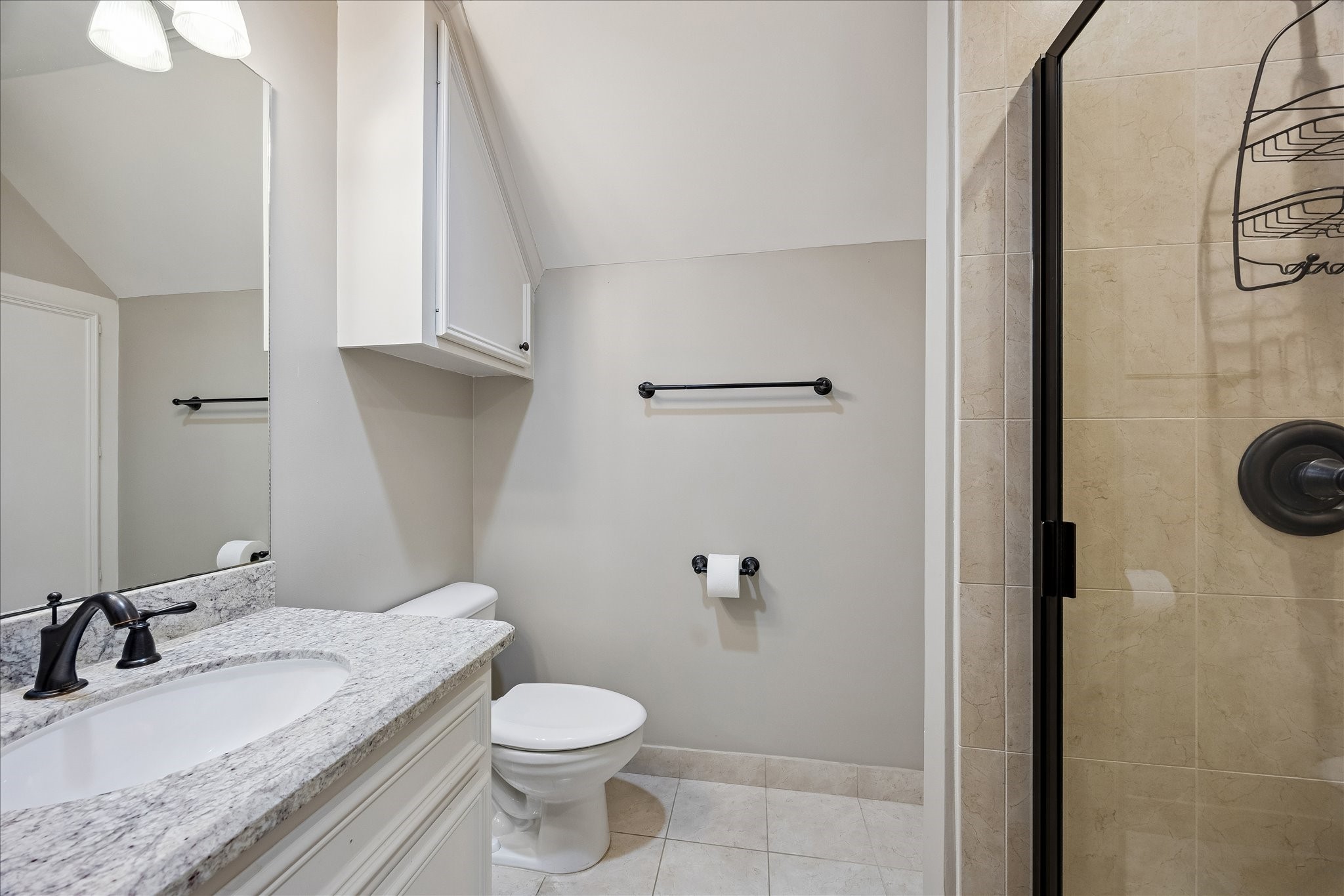 6358 Auden Street Houston, TX 77005 - Photo 38 of 50 a bathroom with a granite countertop sink toilet and a mirror