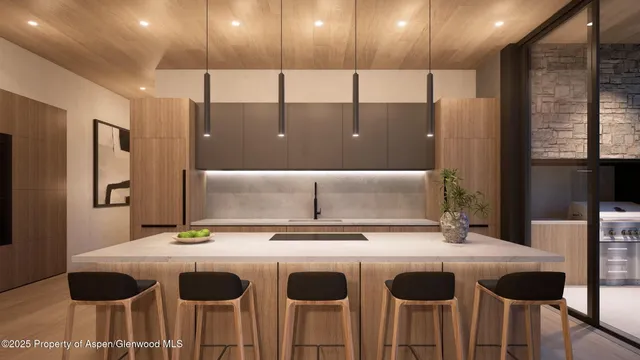 a kitchen with a sink and chairs