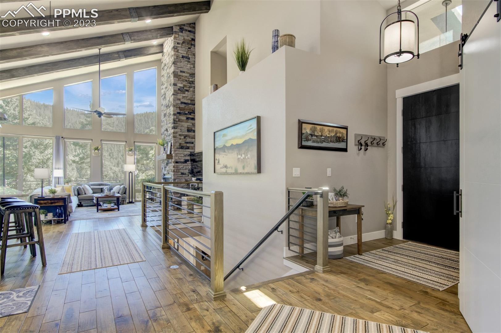 5020 South High Ridge View Manitou Springs, CO 80829 - Photo 4 of 46 Grand foyer with solid white oak flooring, large beamed ceilings windows everywhere and an open concept main level!!!