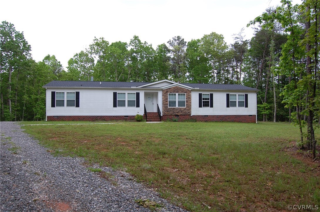 4052 Paynes Mill Road Bumpass, VA 23024 - Photo 1 of 17 a view of a house with backyard and garden